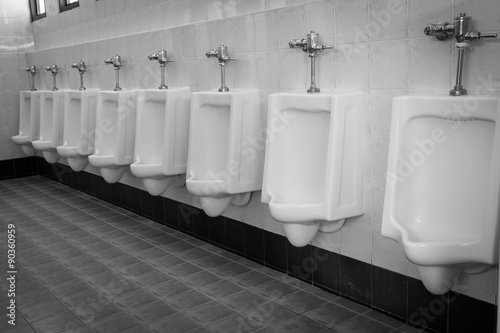 row white urinals in men's bathroom toilet