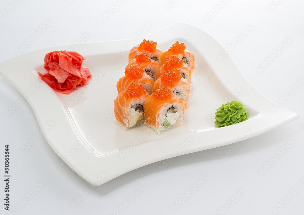 Salmon (philadelphia) sushi roll on a white plate with ginger and wasabi Salmon (philadelphia) sushi roll on a white plate with ginger and wasabi