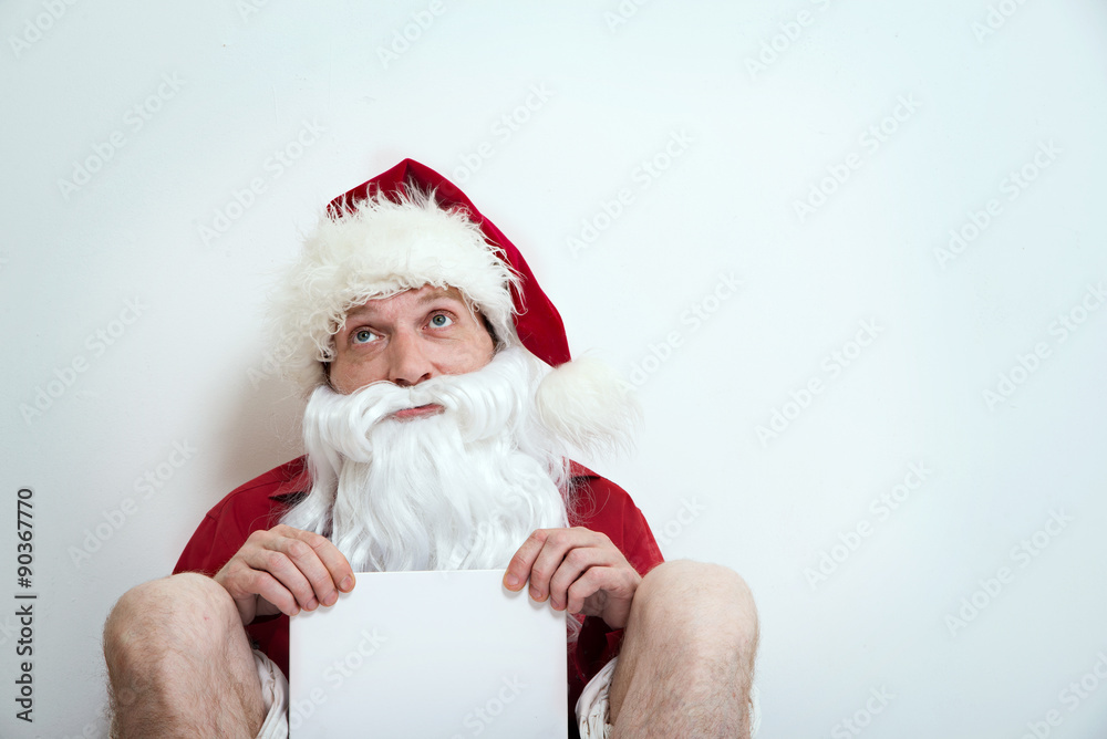 Jobless half naked Santa sit with blank table and looks like beggar Jobless half naked Santa sit with blank table and looks like beggar