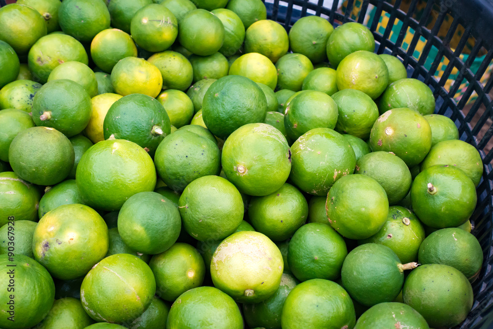 Limes in basket for sell at market. Limes in basket for sell at market.