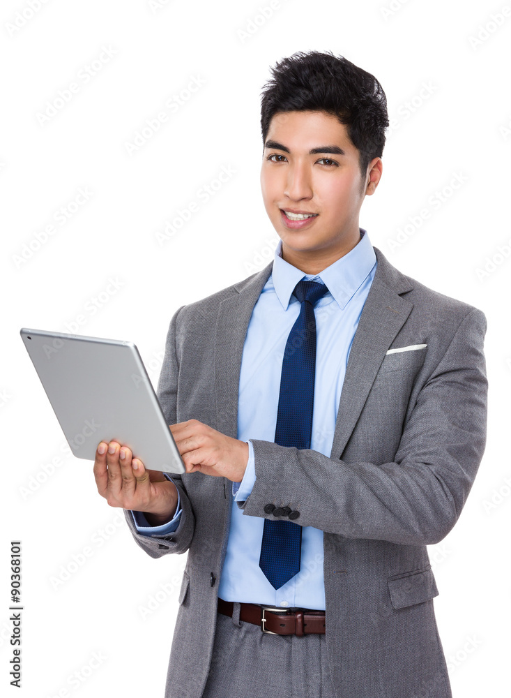 Asian businessman use of the tablet pc Asian businessman use of the tablet pc