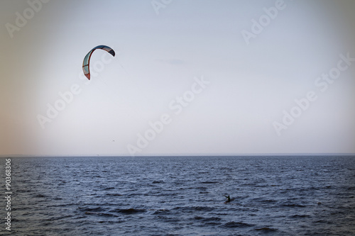 Kite surfer rides on the waves in rever bay 