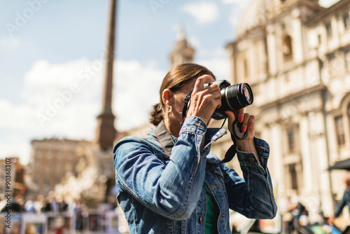 Female brunette tourist photographing architecture of an italian photo