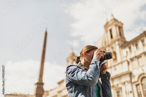 Female brunette tourist photographing architecture of an italian
