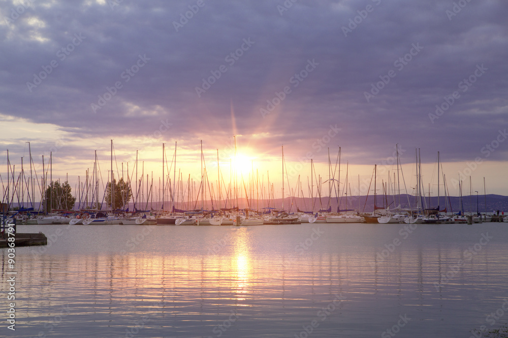 Many yachts and beautiful sunset.
