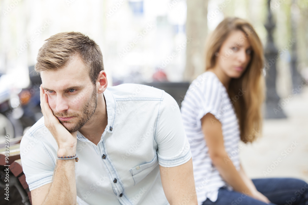 Portrait of young woman and man outdoor on street having relationship problems Portrait of young woman and man outdoor on street having relationship problems