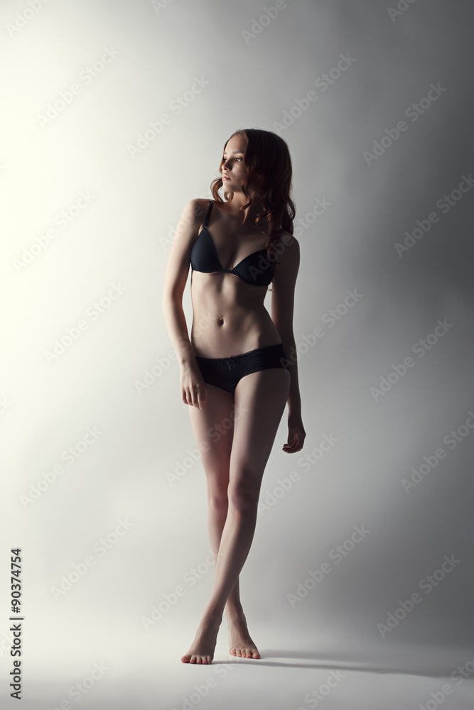 Studio shot of leggy model posing in lingerie