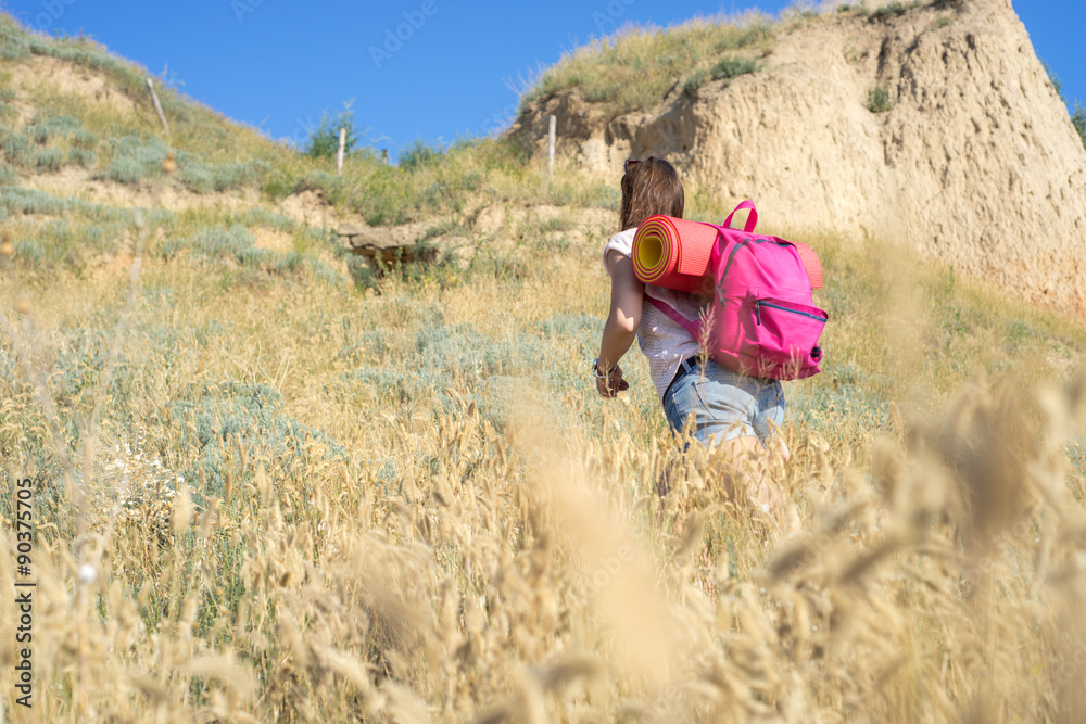 a woman climbs up the hill
