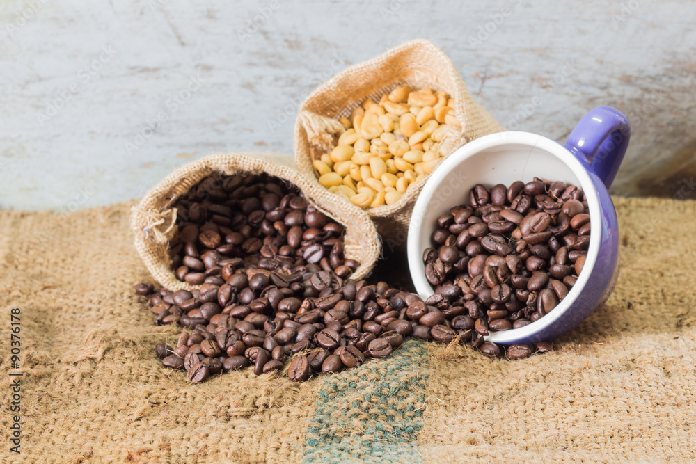 coffee cup and coffee beans on burlap textile and brown background. coffee cup and coffee beans on burlap textile and brown background.