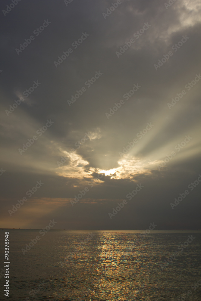 Landscape of cloudy sky which has sun beam and sea water in southern of Thailand