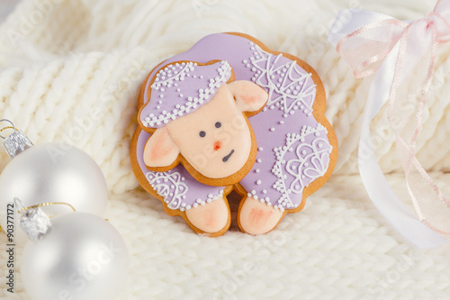 Lavender color gingerbread sheep on white knitted background