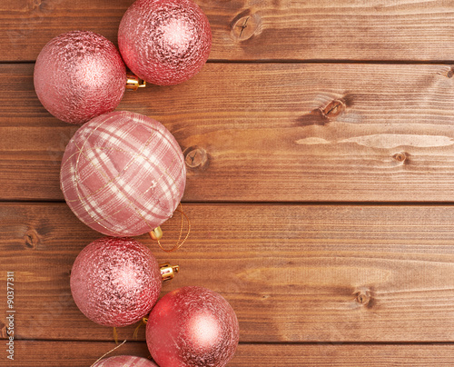 Christmas balls over the wooden background