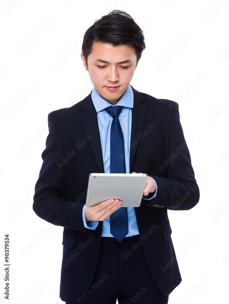 Asian young businessman use of the digital tablet Asian young businessman use of the digital tablet