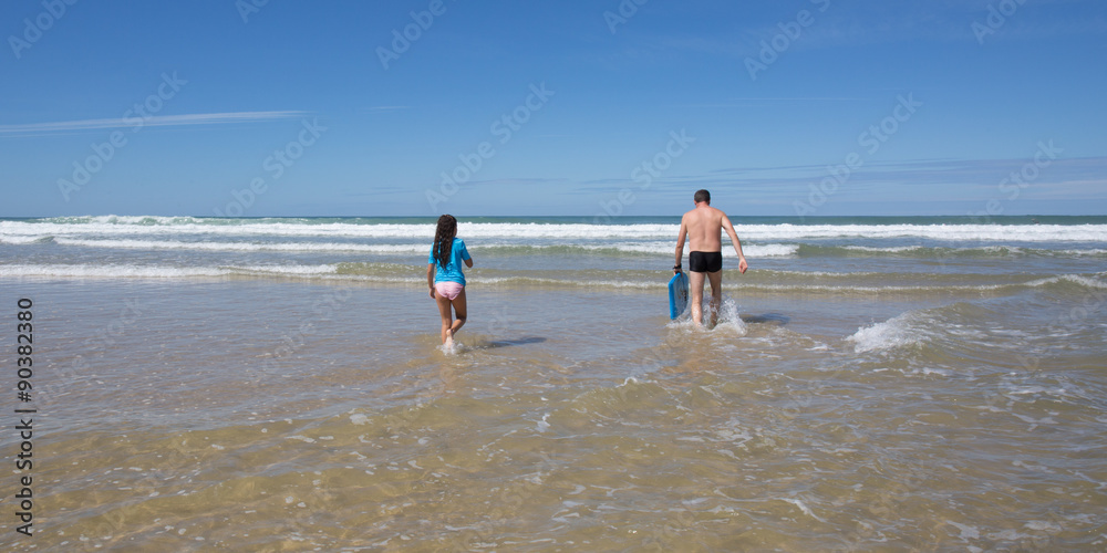 Father and daughter have fun on the beach