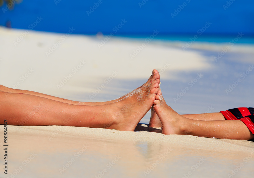 mother and son feet on summer beach mother and son feet on summer beach
