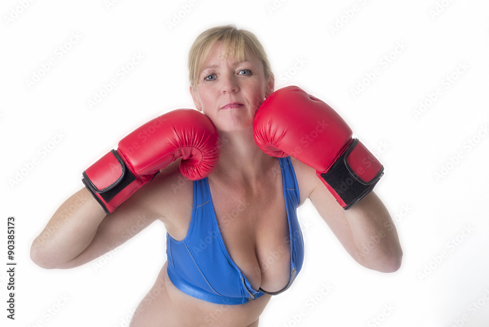 Portrait of a female boxer in a sports bra and red boxing gloves Portrait of a female boxer in a sports bra and red boxing gloves