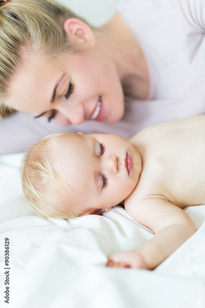 Young mother lying with her little baby
Young mother lying with her little baby