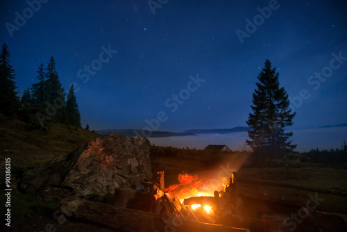 Campfire under blue night sky