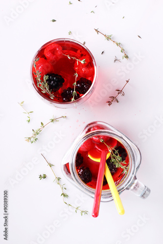 glass of berry drink with fresh fruits on marble table