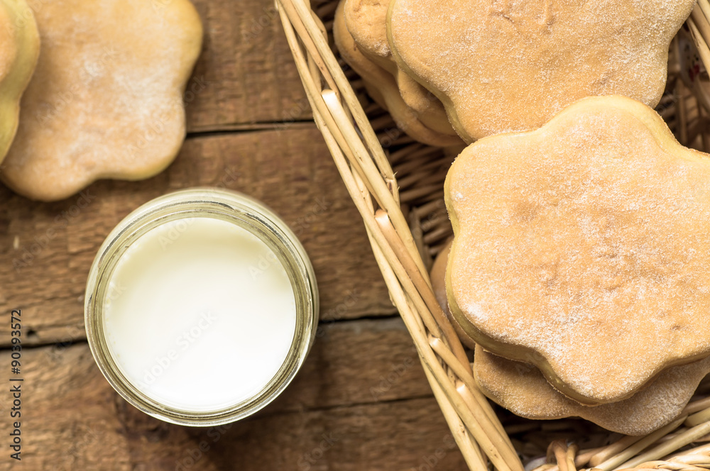 Glass of milk and cookies in a basket Glass of milk and cookies in a basket