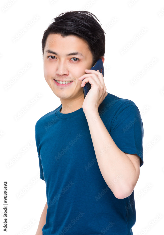Asian young man talk to mobile phone Asian young man talk to mobile phone