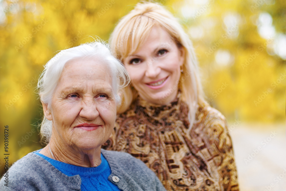 Elderly women with daughter in a garden