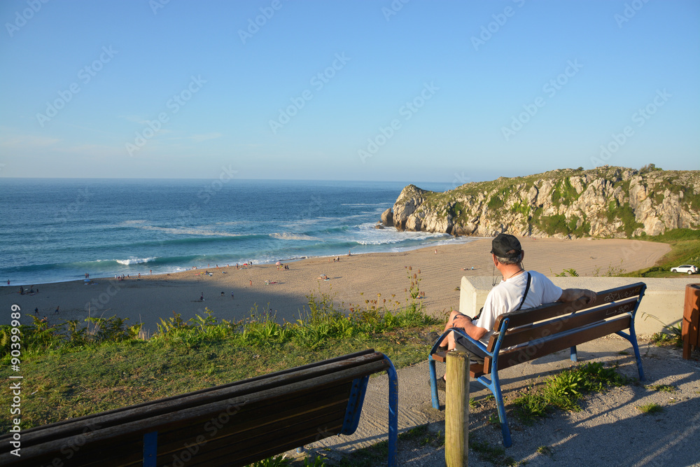 turista disfrutando de las vistas de la Playa de Usgo, Cantabria turista disfrutando de las vistas de la Playa de Usgo, Cantabria