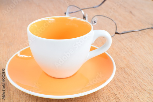 Empty coffee or tea cup on wood board, selective focus