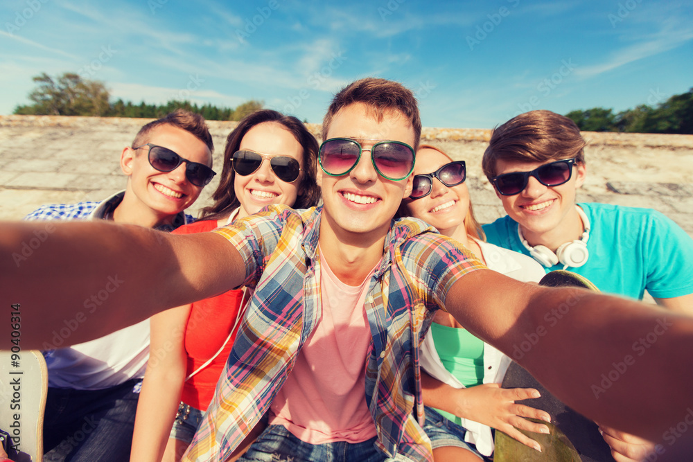 group of smiling friends making selfie outdoors group of smiling friends making selfie outdoors