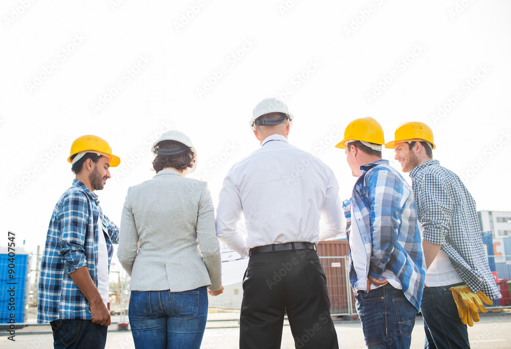 group of builders and architects at building site group of builders and architects at building site