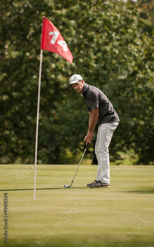  nice man surveying his putt on the fourteenth hole