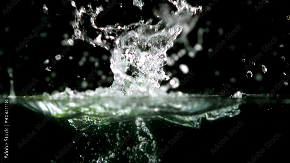 Cucumber slices falling in water Cucumber slices falling in water