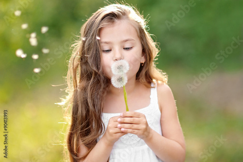 portrait of a beautiful little girl with flowers