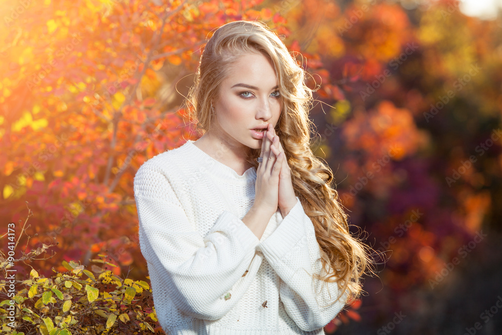 beautiful young woman with curly hair against a background of