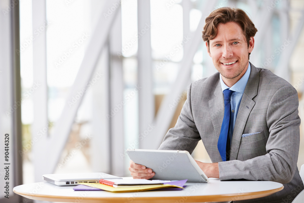 Corporate businessman working with tablet computer Corporate businessman working with tablet computer