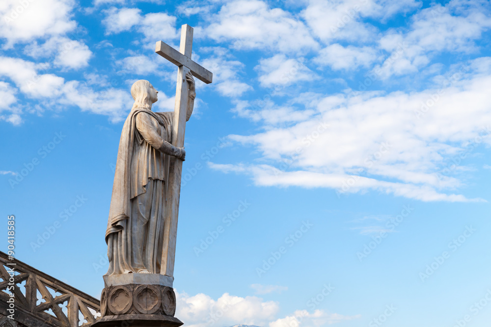 Jesus Christ statue with cross as a part of Saint Francesco Cathedral exterior. Gaeta, Italy