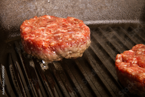 Fresh meat cutlets in a frying pan grill. CloseUp. Toned