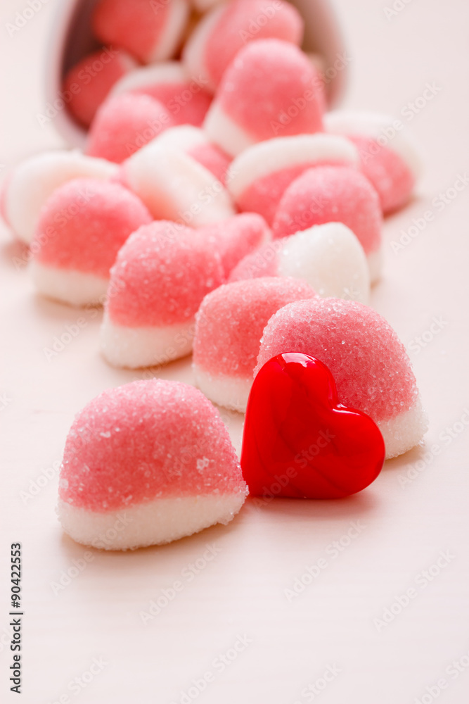 Pink jellies or marshmallows with sugar on table Pink jellies or marshmallows with sugar on table