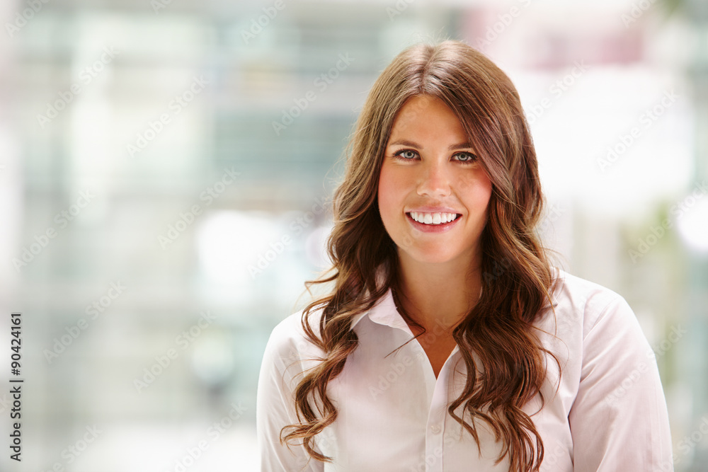 Head and shoulders portrait of a young businesswoman smiling Head and shoulders portrait of a young businesswoman smiling