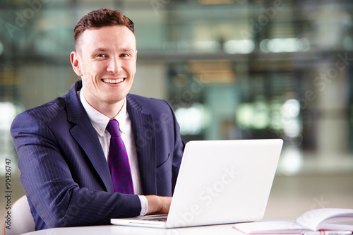 Young Caucasian businessman using laptop computer at work © Monkey Business