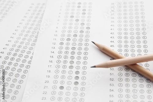 Standardized test form with answers bubbled in and a pencil, foc
