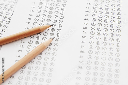 Standardized test form with answers bubbled in and a pencil, foc