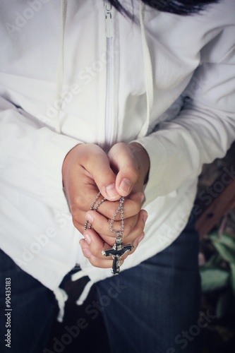 Hands praying with cross © Successo images