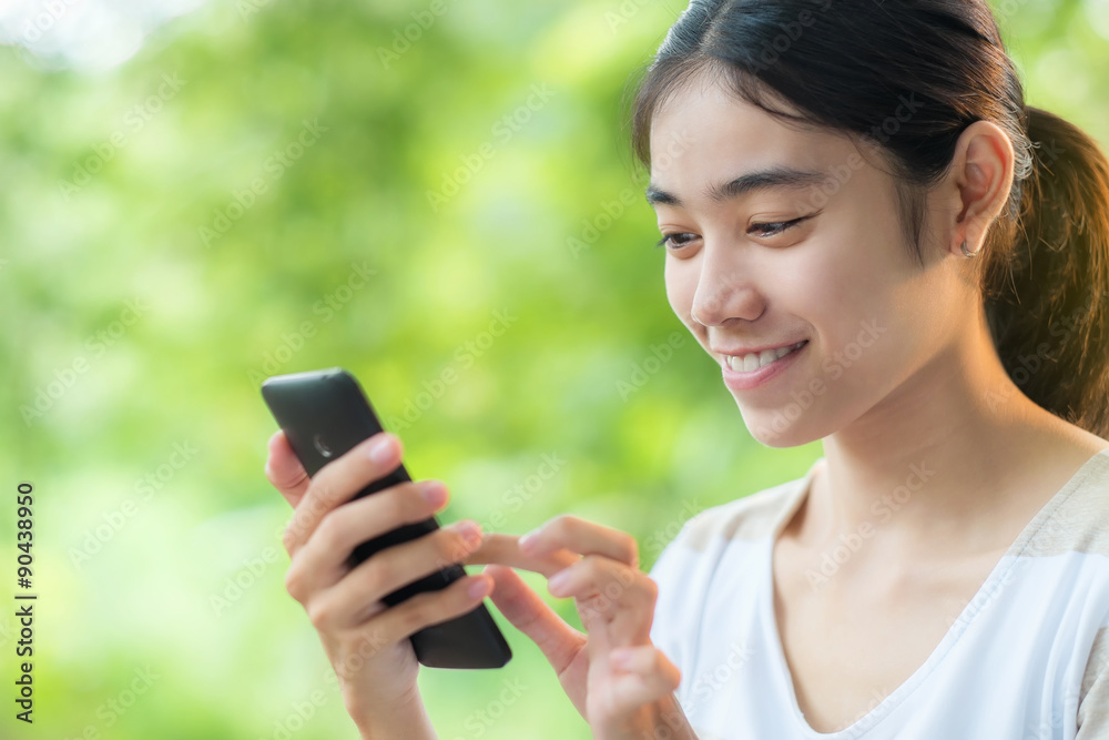 Asian teen woman using smartphone Asian teen woman using smartphone