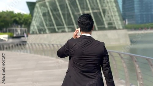 Young angry asian male professional walking away