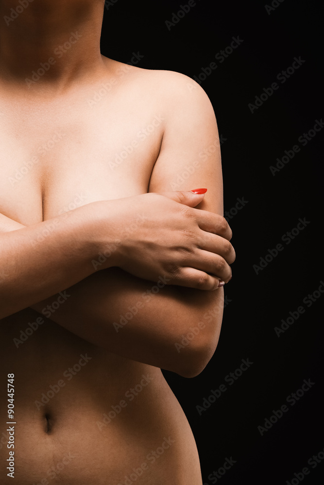 Fotka „Portrait of a Asian sexy woman covering her breast with hands  isolated over black background.“ ze služby Stock