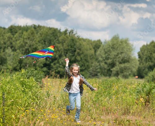little cute girl flying a kite 