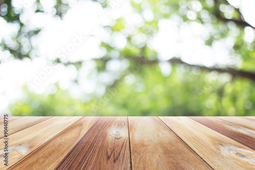 Close up wooden table with nature blurred background