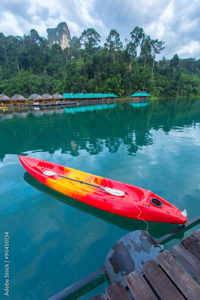 Canoe in a beautiful mountains lake forest and river natural attractions in Ratchaprapha Dam at Khao Sok National Park, Surat Thani Province, Thailand. Canoe in a beautiful mountains lake forest and river natural attractions in Ratchaprapha Dam at Khao Sok National Park, Surat Thani Province, Thailand.