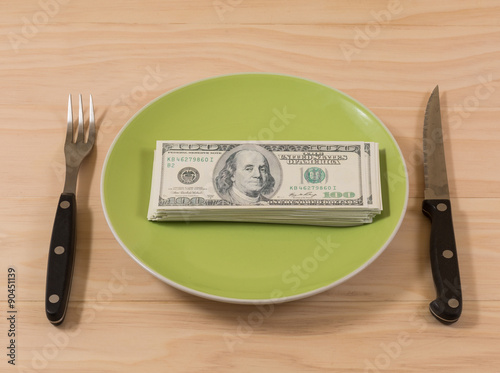 Dollar bills in plate photo